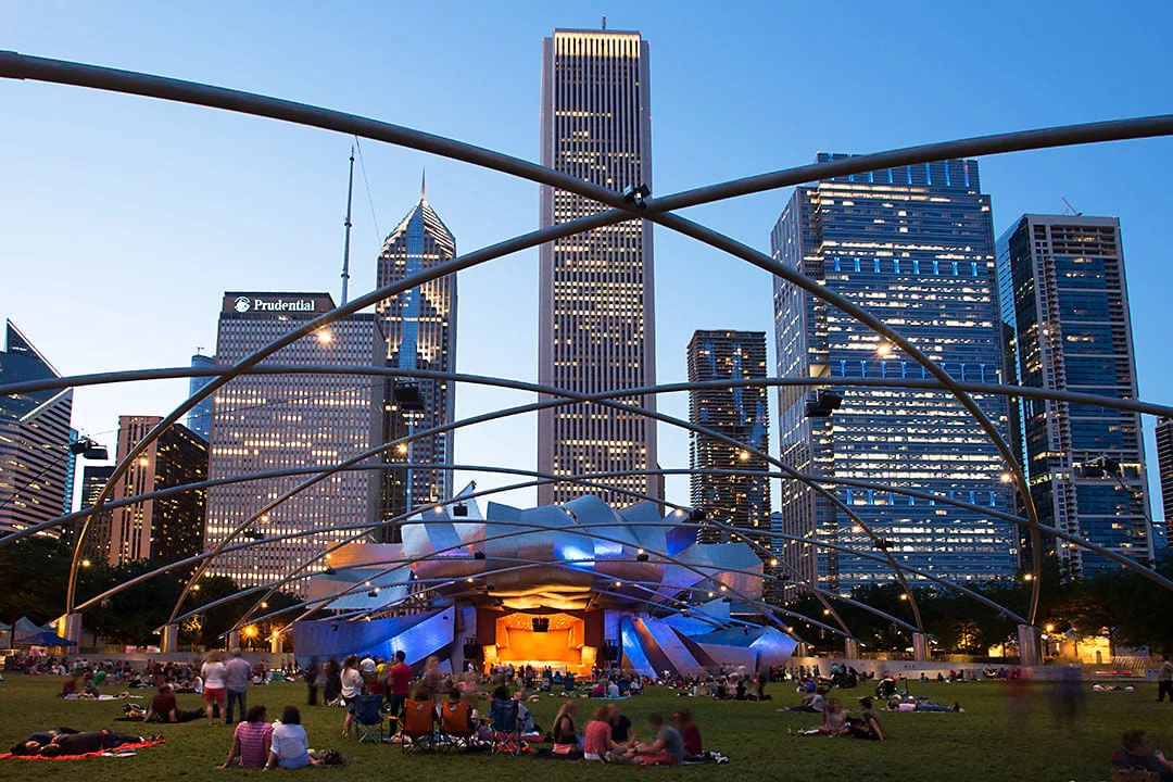 Chicago summer event at Millennium Park with crowds enjoying an outdoor concert at the Jay Pritzker Pavilion.