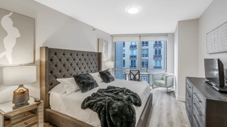 Modern corporate housing apartment in Chicago with luxury furnishings and spacious bedroom.