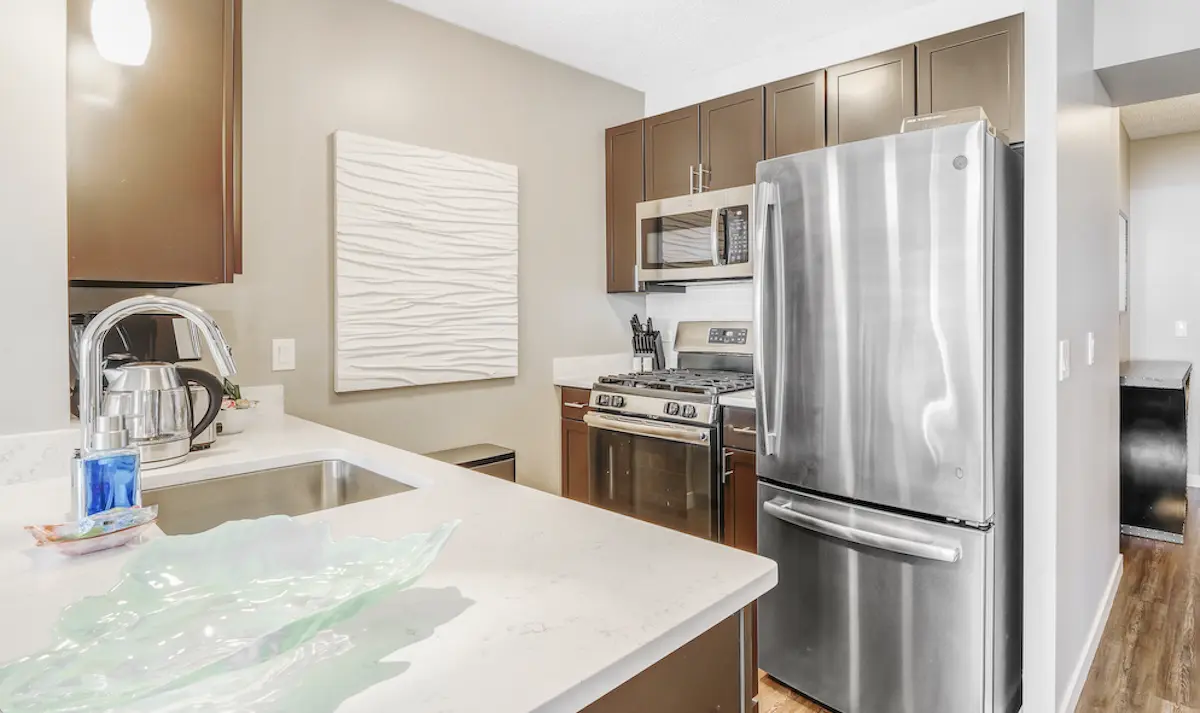 Modern furnished apartment interior in Chicago showing a fully equipped kitchen highlighting the benefits of furnished rentals.