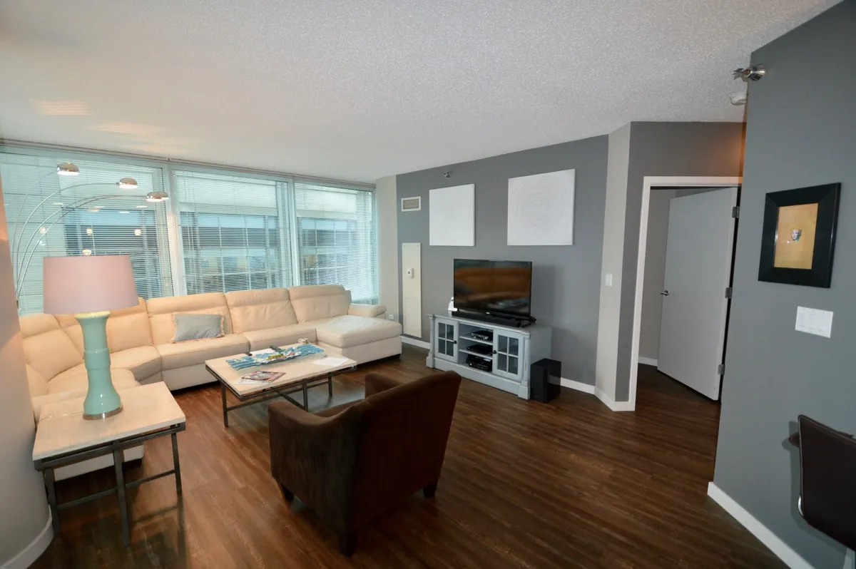 Modern furnished apartment in Chicago compared to a hotel room for extended-stay living.