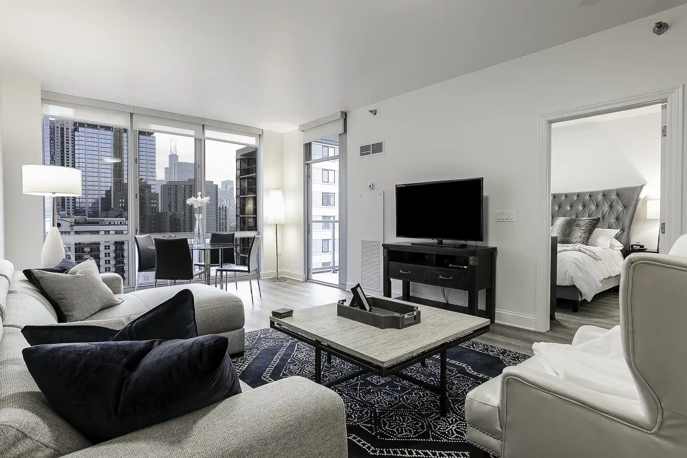 Luxury furnished short-term rental apartment in Chicago with modern living room design and skyline views.
