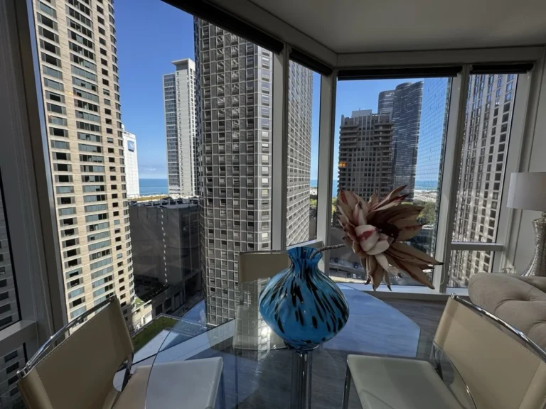 Luxury furnished apartment in downtown Chicago with floor-to-ceiling windows and city views.